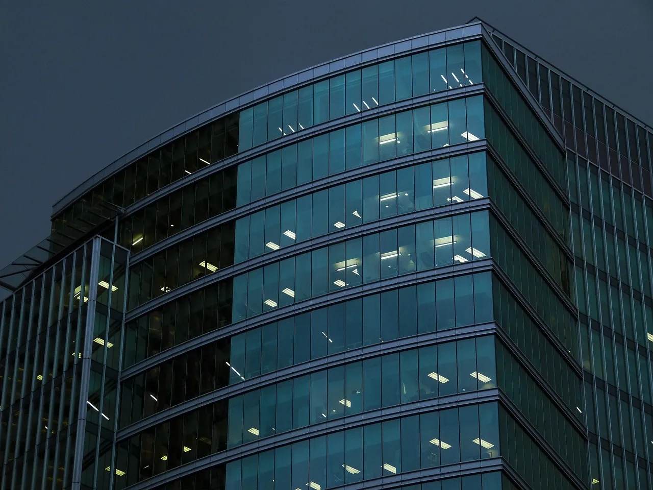 night scene, building, high rise, downtown, vancouver, british columbia, canada, architecture, blue glass, facade, modern, construction, blue construction. The costliest commercial buying mistakes, explained
