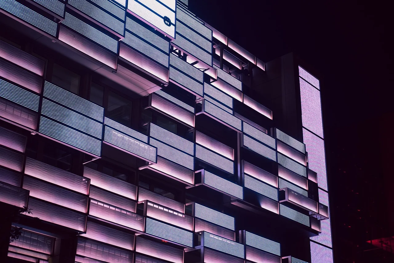 building, architecture, facade, skyscraper, building exterior, modern building, office building, residential building, apartment, city, town, urban, illuminated, night, evening. Commercial rent per square foot by US market: what to verify before you sign