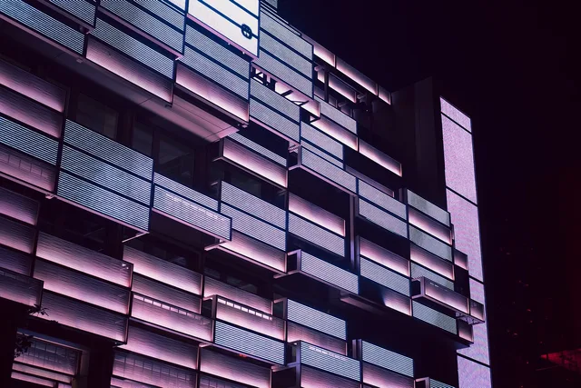 building, architecture, facade, skyscraper, building exterior, modern building, office building, residential building, apartment, city, town, urban, illuminated, night, evening. Commercial rent per square foot by US market: what to verify before you sign