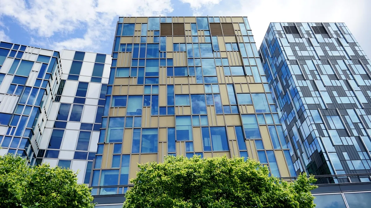 building, glass, architecture, office, modern, blue, window, sky, urban, corporate, city, reflection, tower, tall, structure, facade, exterior, futuristic, commercial, workplace, light, steel, district, design, downtown, high, business, high-rise, estate, construction, nature, cityscape, blue sky, apartment, residence, suburb, sony a7, blue office, blue construction, blue window. SBA 504 and 7(a) loans for owner-occupied workspace, what lenders require